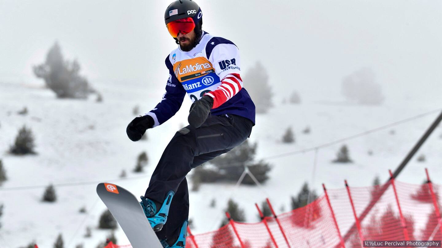 Athlete competes in snowboard competition. 