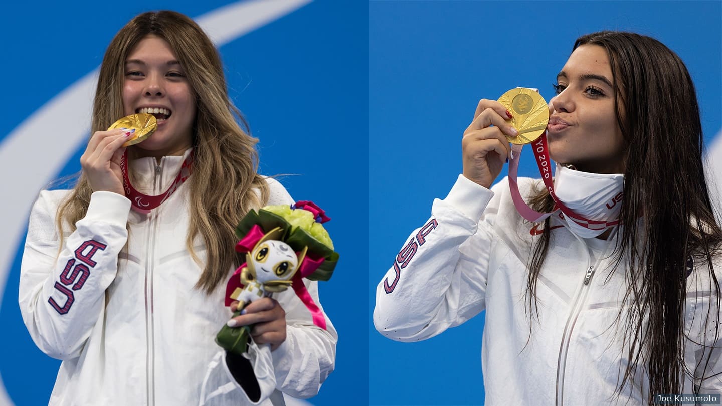 Gia Pergolini and Tas Pagonis hold up gold medals during medal ceremony. 