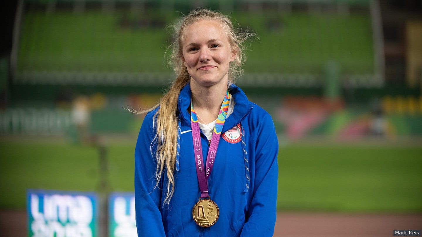 Jessica Heims smiles for camera on the medal stand at the ParaPan American Games. 