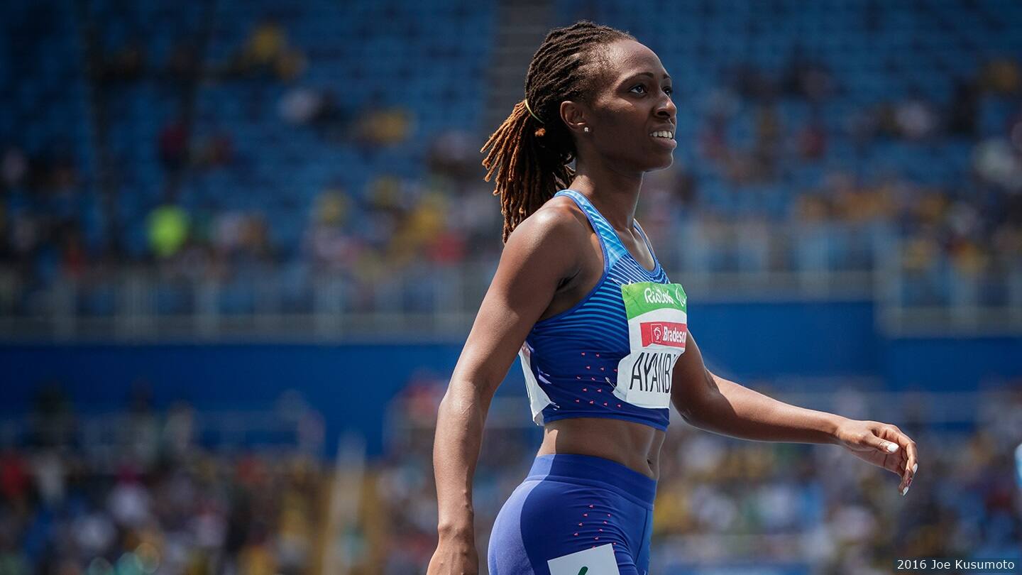 Athlete looks into crowd after race. 
