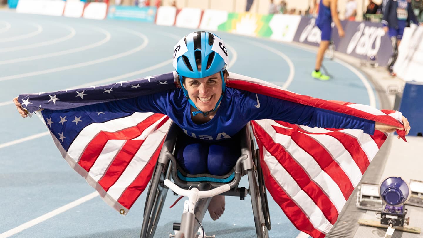 Kerri Morgan poses for camera with American flag. 