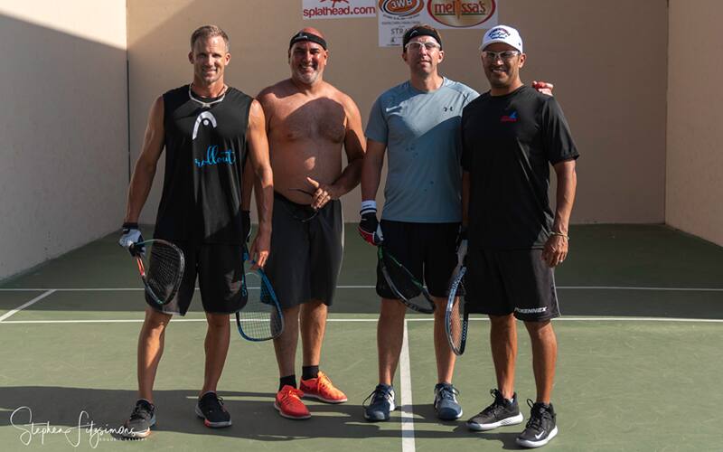 Four racquetball players outdoor.