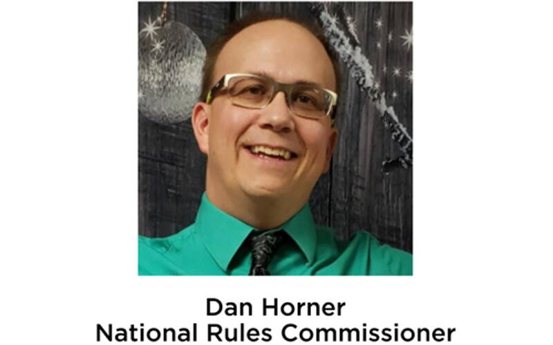 Dan Horner headshot green shirt.