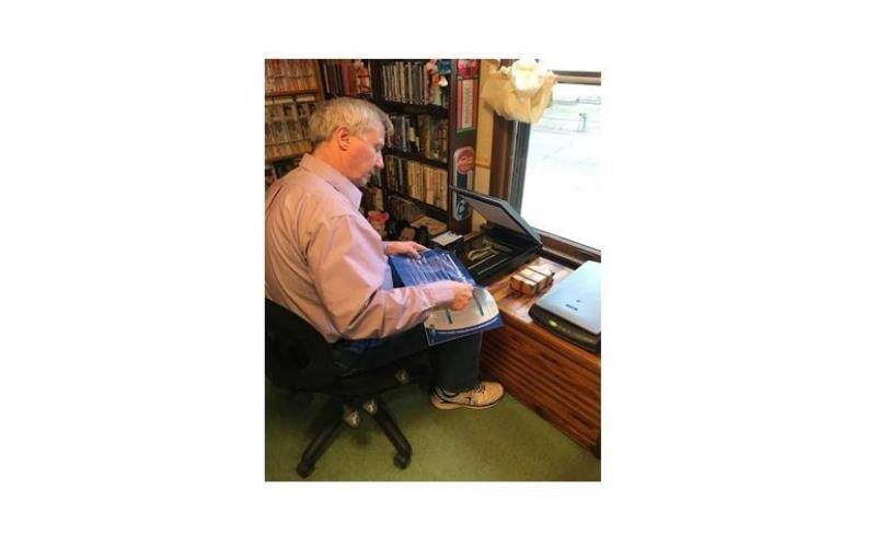 Jim Easterling archiving magazines at his desk