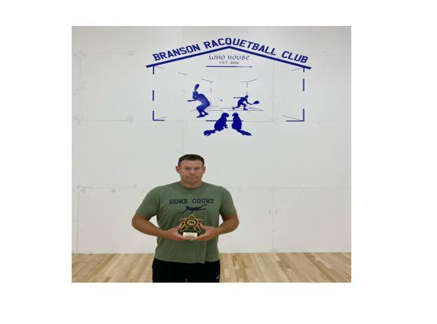 Thomas Davis on court with his Real Racquetball Champion award