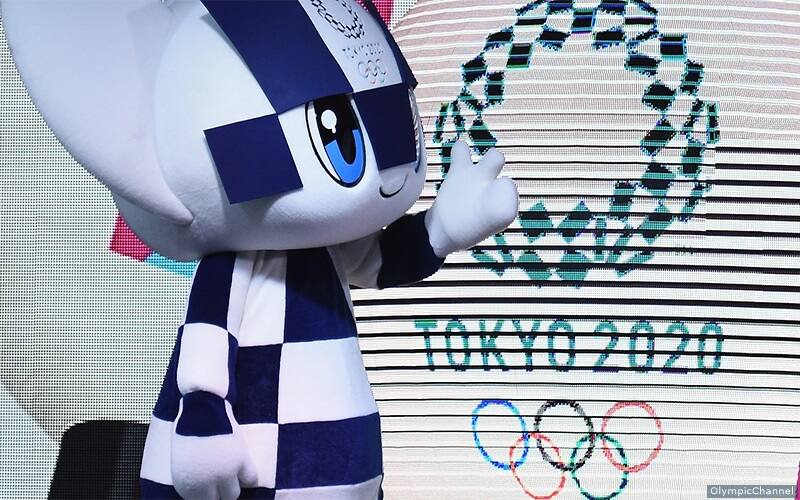 Olympic rings for Tokyo 2020 and a Tokyo games mascot - white and blue checkered cat. 