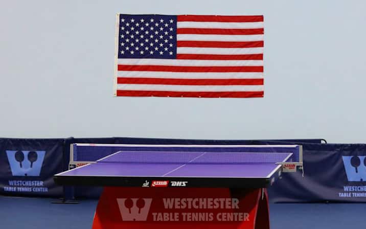 Double Happiness table under and American flag at Westchester Table Tennis Clubin Pleasantville, NY. May 2022.