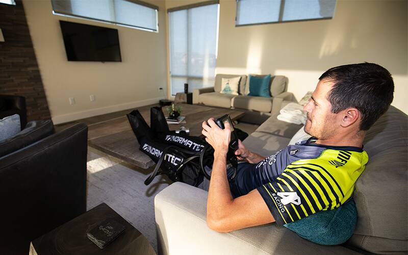 Man sitting with normatec on his legs
