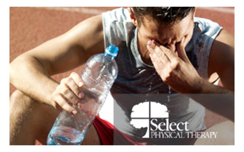 Athlete rubbing his forehead drinking water