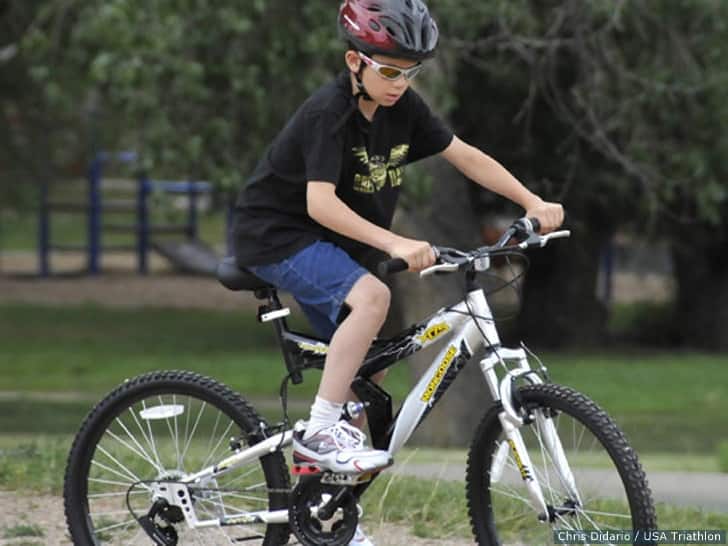 A local youth from Colorado Springs takes a spin on his new bike