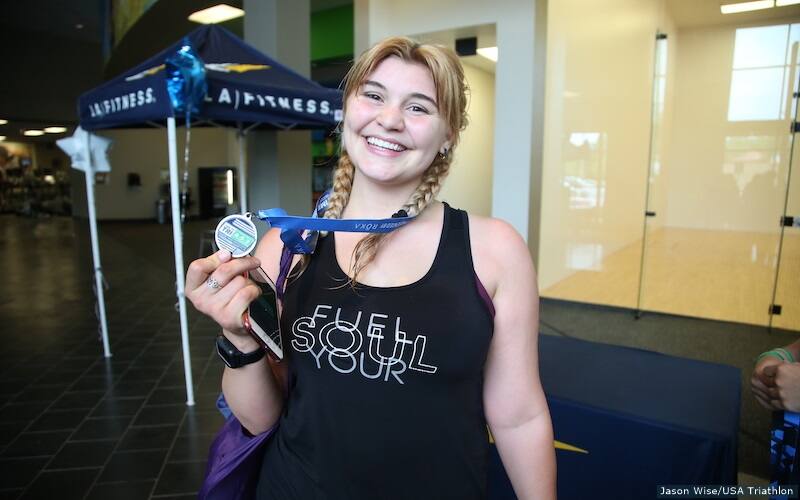 showing medal off after race