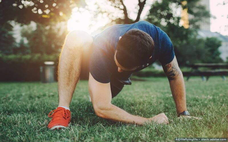 man stretching in grass
