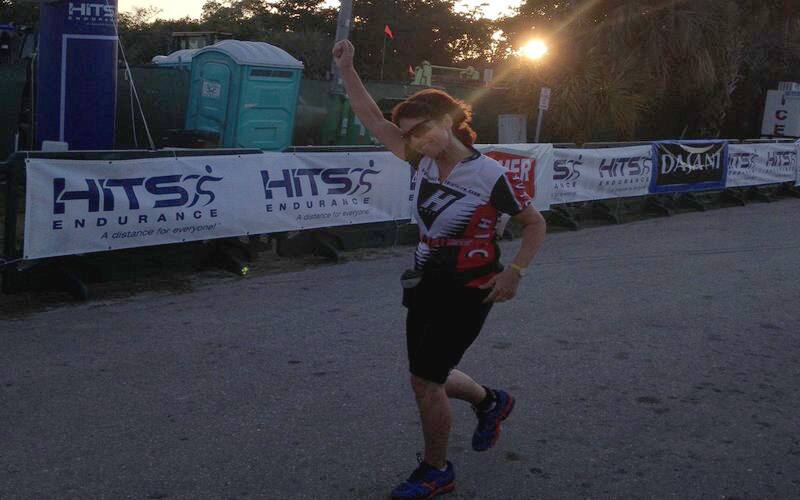 Sally nearing the finish with her arm raised