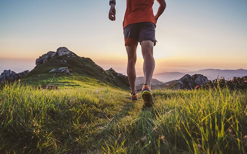 man trail running in the mountains