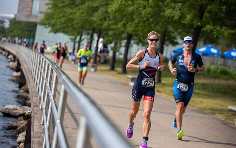 Athletes run along water