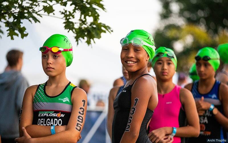 youth triathletes smiling at a race