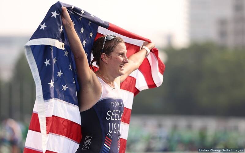 allysa seely at the tokyo 2020 paralympics holding an american flag