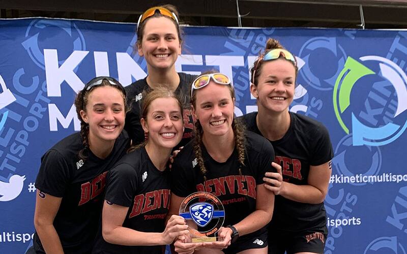 five members of the university of denver women's collegiate triathlon team pose for a photo holding the first place trophy from the smith mountain lake regional qualifier