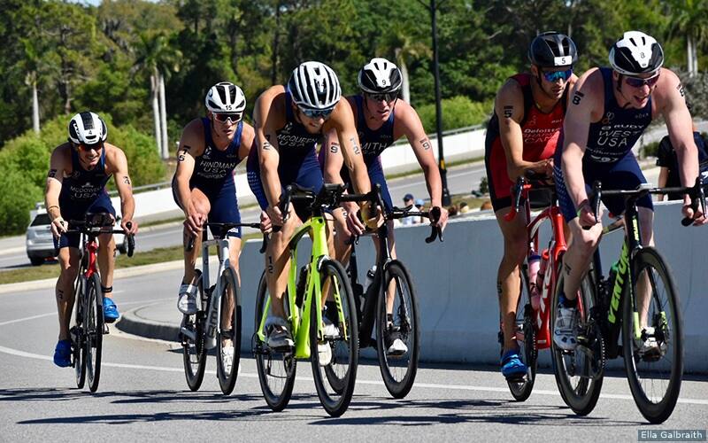 triathlete race in a pack on the bike
