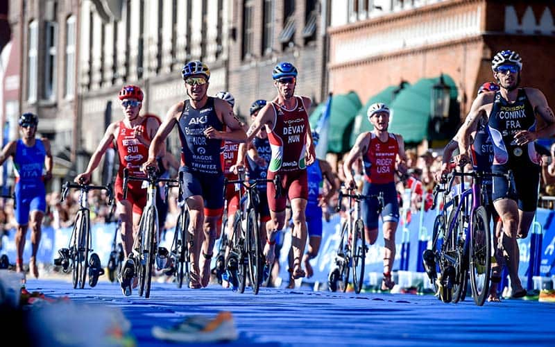 elite men make their way through T2 in Bergen Norway