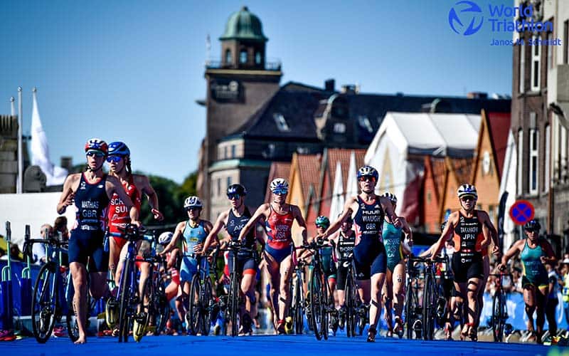 Kirsten Kasper and other elite athletes run through transition in Bergen, Norway
