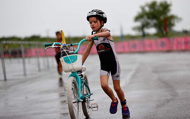 young triathlete transitions on their bike at youth nationals in West Chester