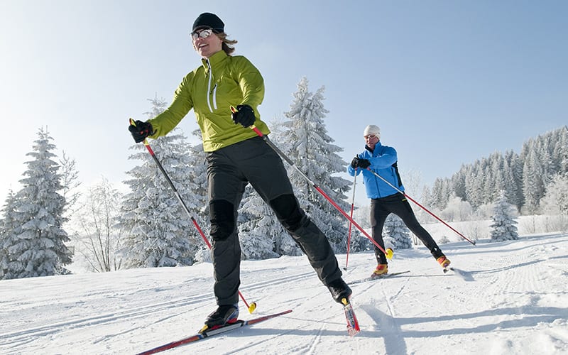 two people cross country skiing
