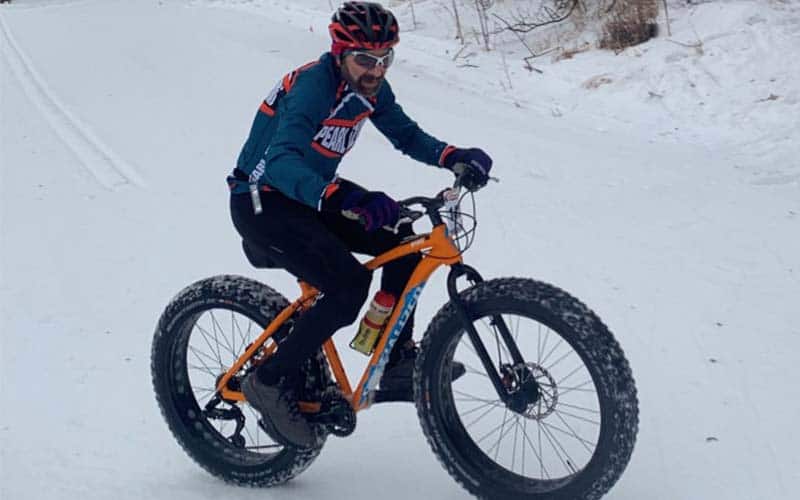 Athlete on his bike in the snow at winter triathlon nationals