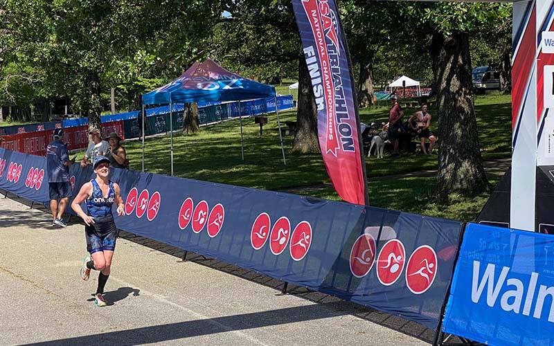 athlete crosses the finish line at the gravel triathlon national championship