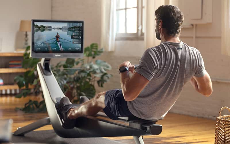 man using a hydrow rowing machine