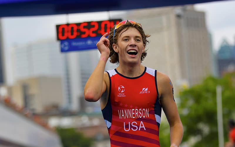 Photo of Junior triathlete Reese Vannerson wearing a red USA triathlon suit.
