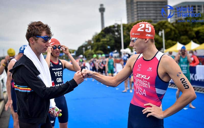 Chase McQueen pumps a fist with another athlete ahead of WTCS Yokohama