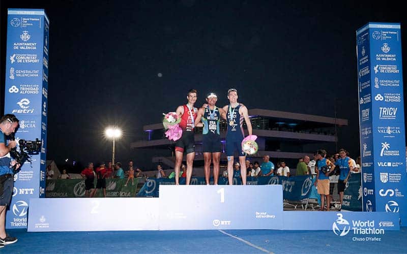 matt McElroy stands on the World Cup Valencia podium