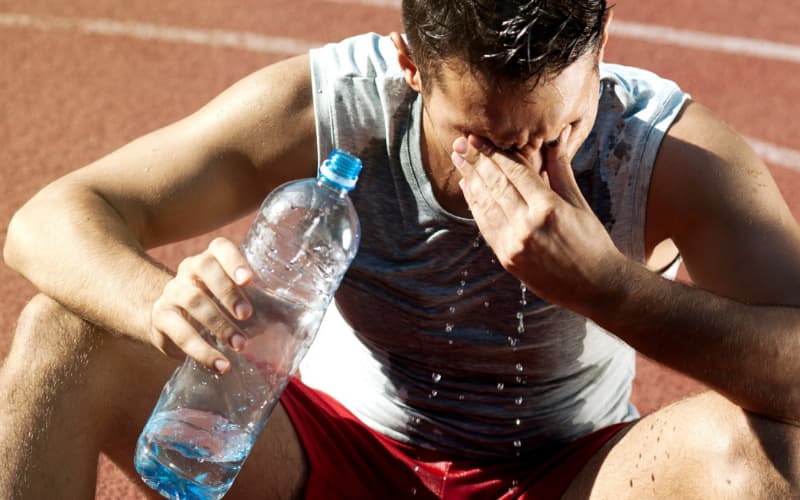 Image of athlete drinking water