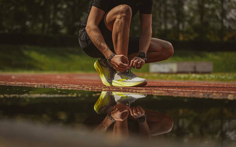 Athlete tying his shoe