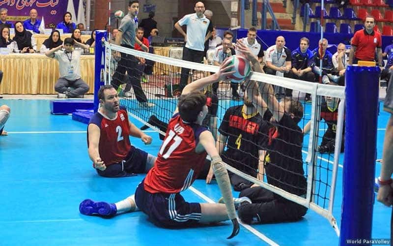 Zach Upp jousts with players from Germany during a sitting volleyball match in Iran