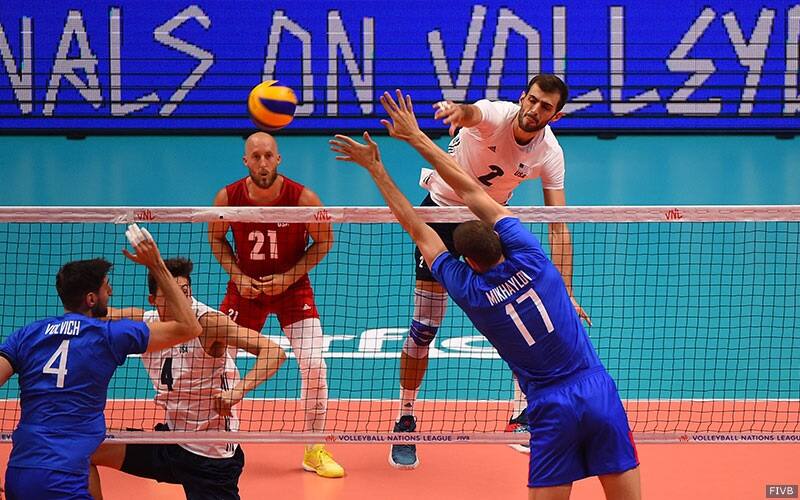 U.S. Men's volleyball player Aaron Russell attacks against Russia