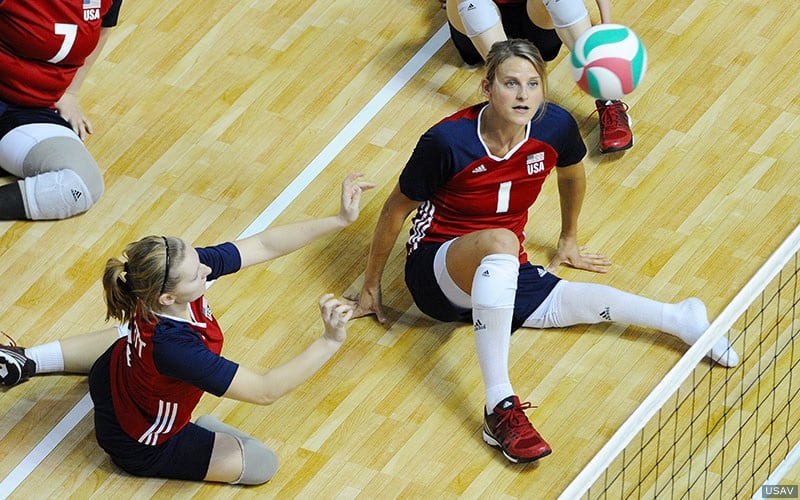 U.S. Women's Sitting Volleyball player Lexi Shifflett sets the ball as Lora Webster watches
