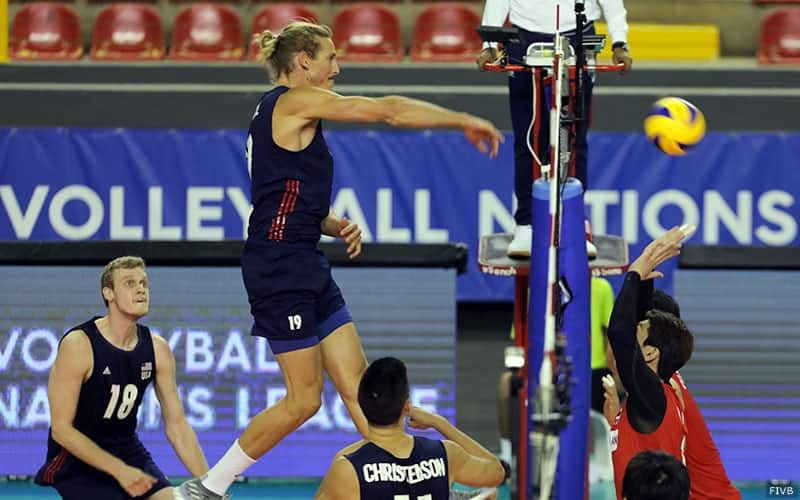 U.S. volleyball player Taylor Averill attacks against Korea as Jake Langlois watches