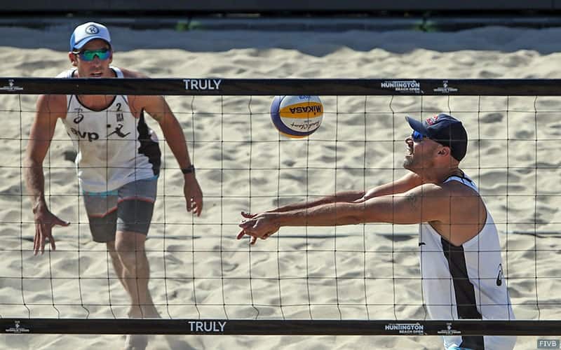 Beach volleyball player Phil Dalhausser sets the ball for partner Nick Lucena