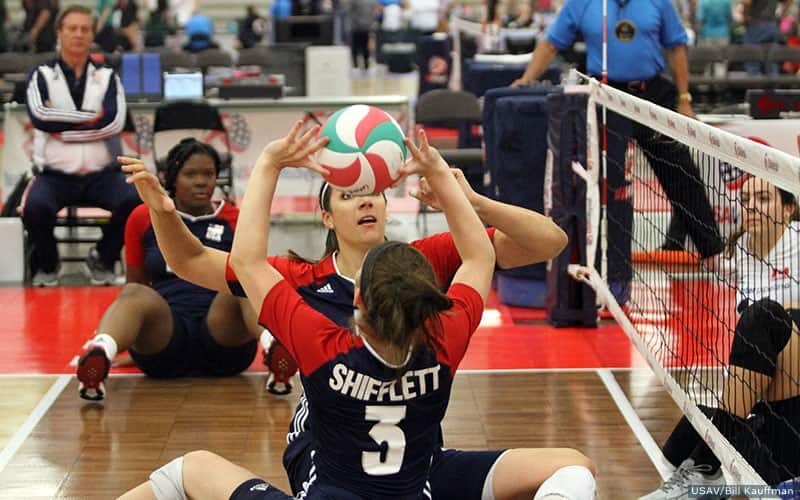 Sitting volleyball player Lexi Shifflett sets for teammate Katie Holloway