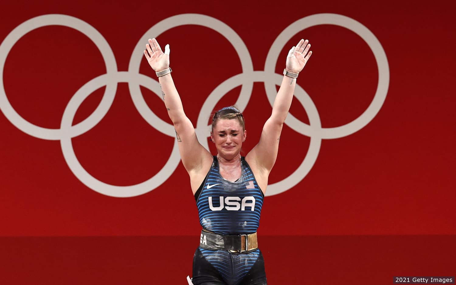 Mattie Rogers waves after completing her final clean and jerk lift at the Olympic Games