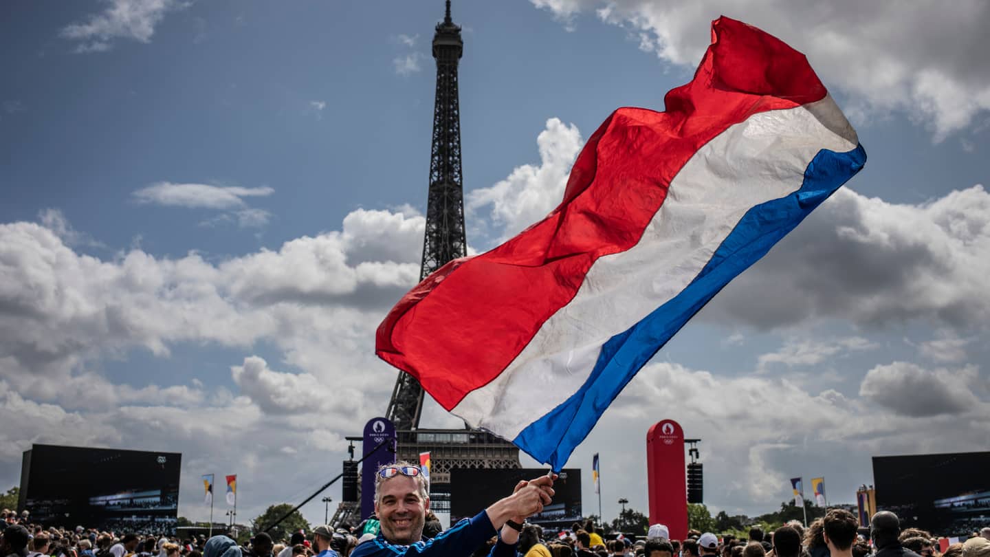 France's flag waves in front of Eiffel Tower