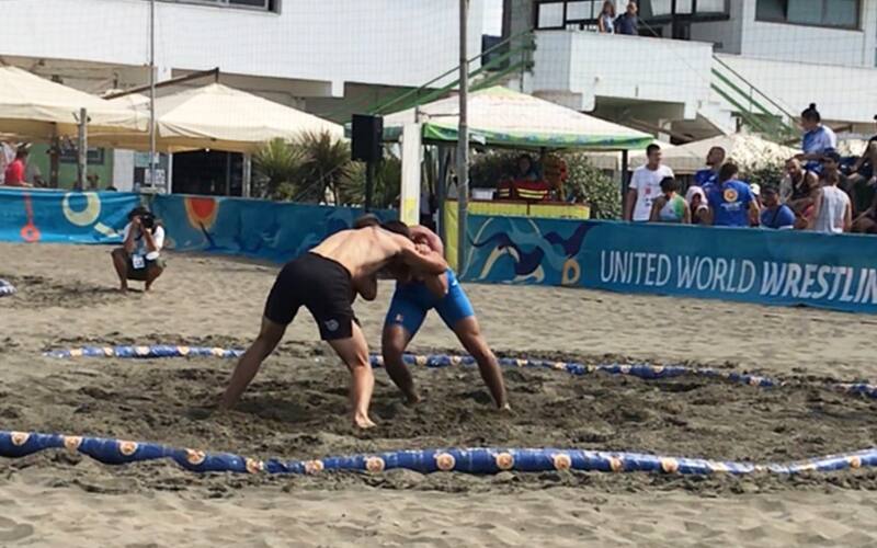 Michael Peters (USA) locks up with Stefan Ionut Coman (ROU) at Rome Beach World Series. 