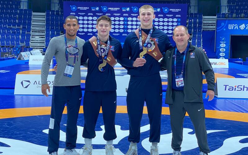 Coach Kendric Maple, Junior World champions Keegan O'Toole and Rocky Elam, and coach Brian Smith pose together at the Junior Worlds in Russia.
