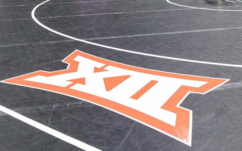 Wrestling mat with a Big 12 logo on it