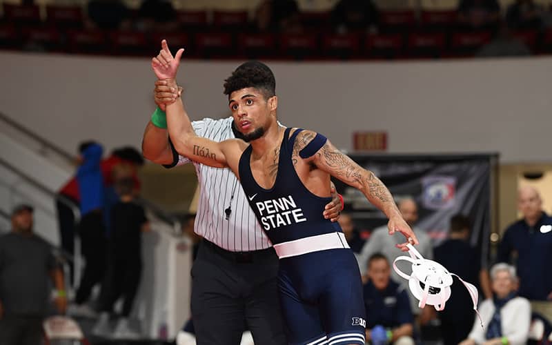 Roman Bravo-Young gets his hand raised after winning a match at the 2021 Collegiate Duals