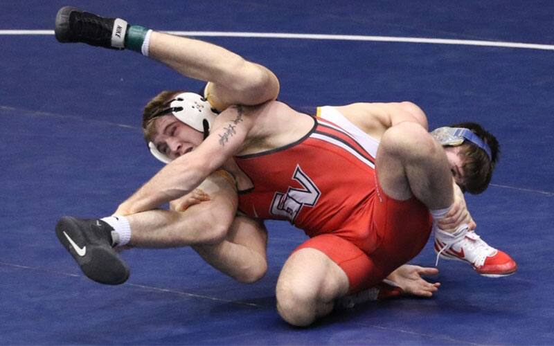 Action image of Grand View men's wrestler in on a single leg