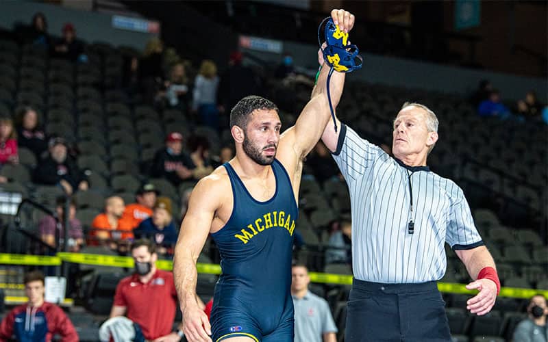 Myles Amine of Michigan has his arm raised at the Matmen Open