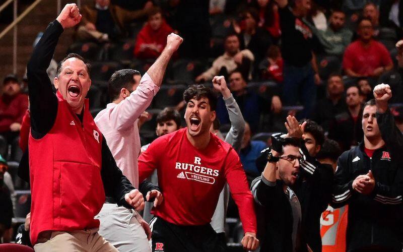 The Rutgers wrestling bench celebrates after a big win in the Garden State Grapple.